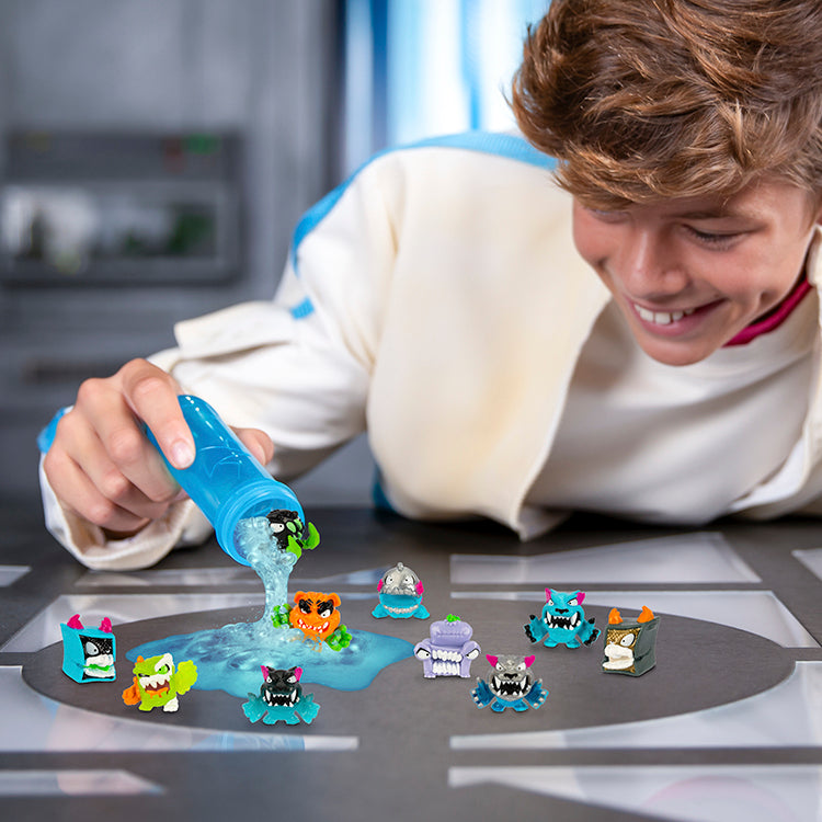 Boy pouring blue liquid to create MrBeast Lab Swarms characters from test tube on a tabletop.