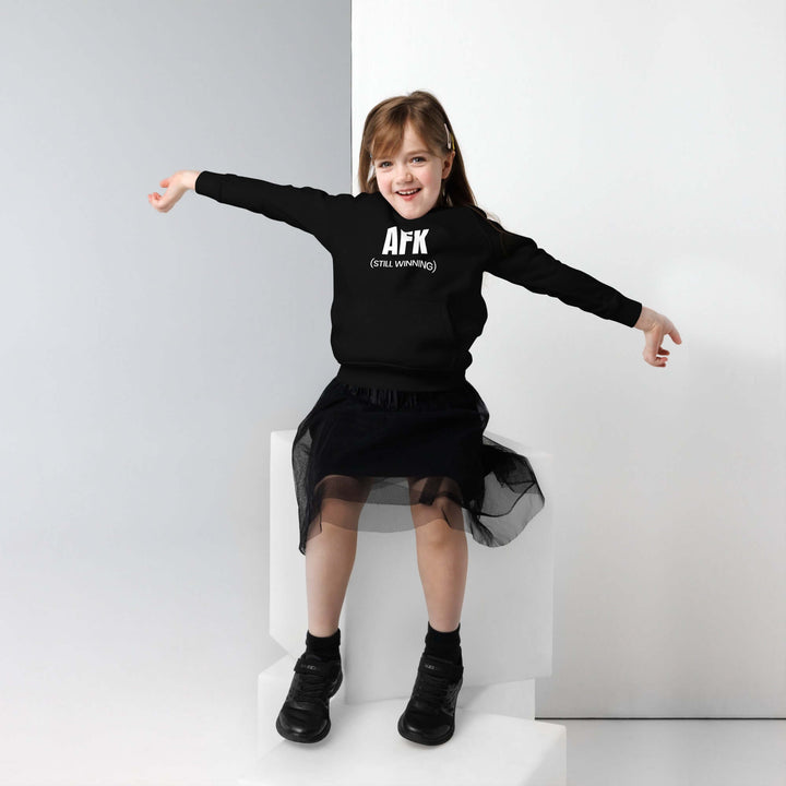 Young child wearing an AFK Kids eco friendly hoodie, smiling and posing in a stylish outfit.