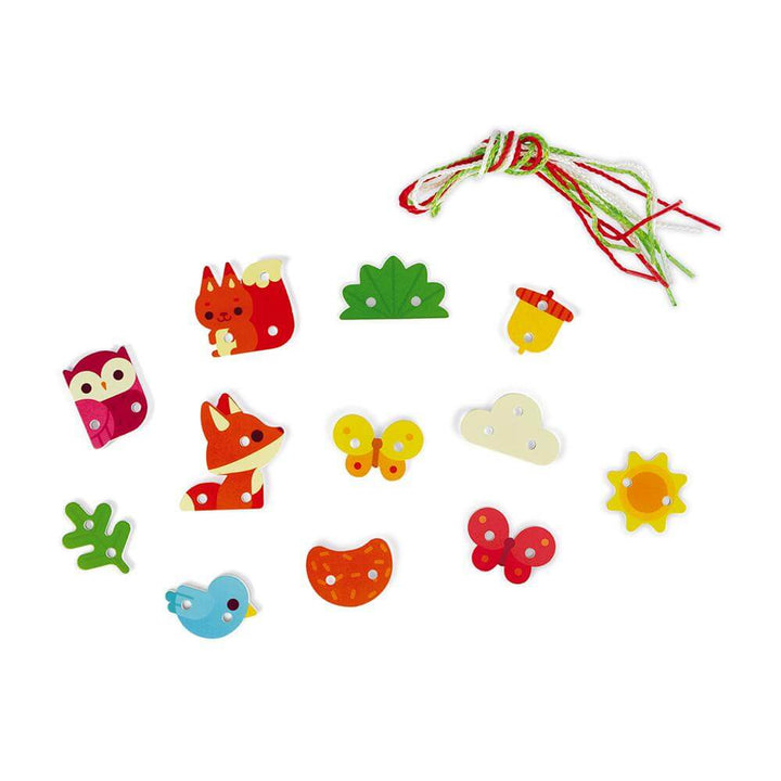 Colorful wooden tree decorations and laces for the Lace Up Tree toy, featuring animals and shapes for fine motor skills development.